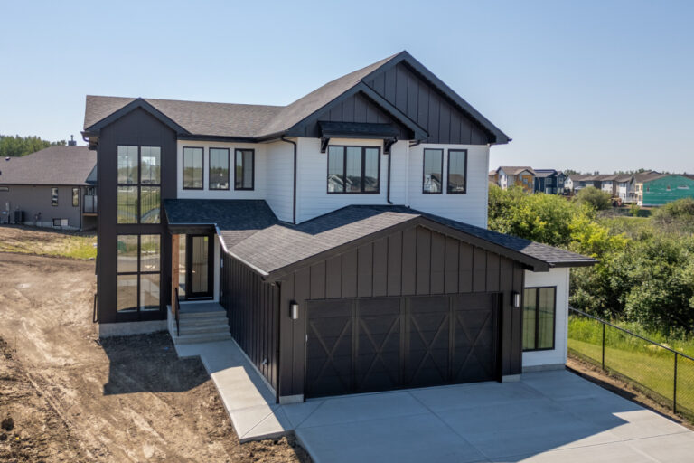 Modern white and black residential home with well-maintained siding and exterior features in Edmonton.