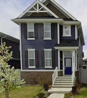 Residential home with blue exterior siding installed by Edmonton siding contractors.