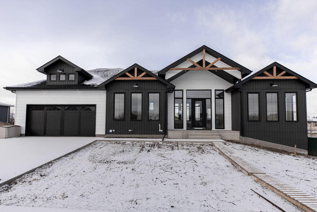 Modern white and black home with well-maintained siding, showcasing exterior durability and curb appeal in Edmonton.
