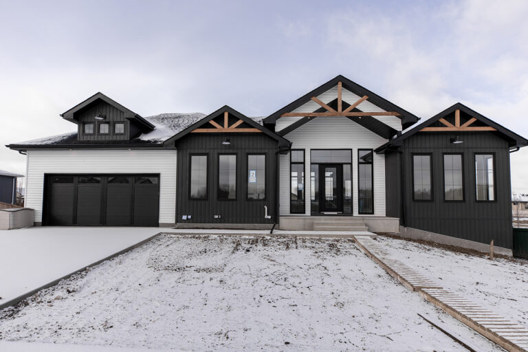 Modern white and black home with well-maintained siding, showcasing exterior durability and curb appeal in Edmonton.