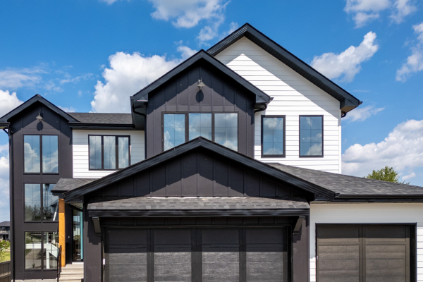 Residential home with black and white exterior siding installed by Edmonton siding contractors.
