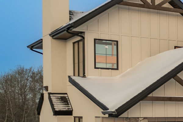 Close-up of cream-colored custom home exterior showing gutters and siding detail in Edmonton.
